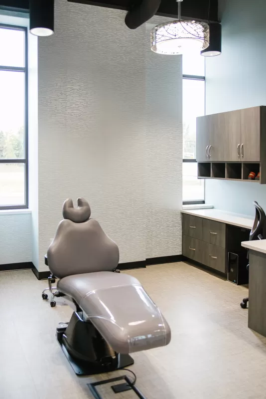 interior-impressions-horton-orthodontics-woodbury-mn-dentist-office-grey-dental-chair-wood-cabinets-beige-walls